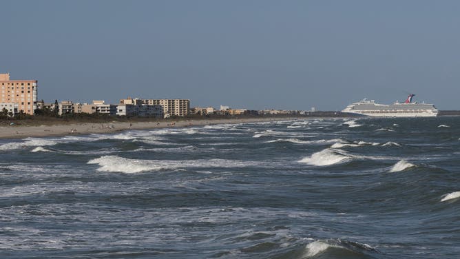 Cocoa Beach, Florida, Cruise ship enters Port Canaveral from the Atlantic Ocean viewed from Cocoa Beach on the space coast Florida.