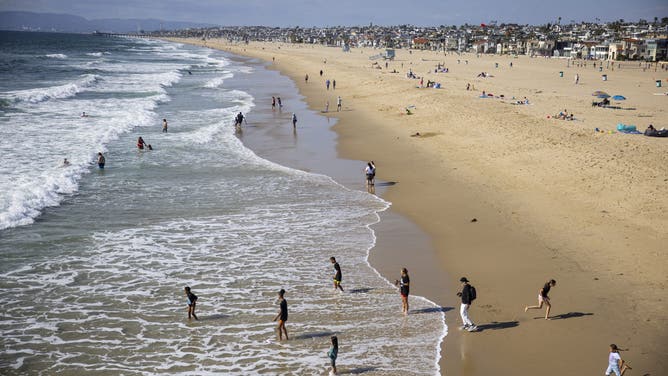 HERMOSA BEACH, CA - APRIL 02, 2026: Visitors enjoy the water next to the Hermosa Beach Pier on Thursday, April 2, 2026, in Hermosa Beach, CA.