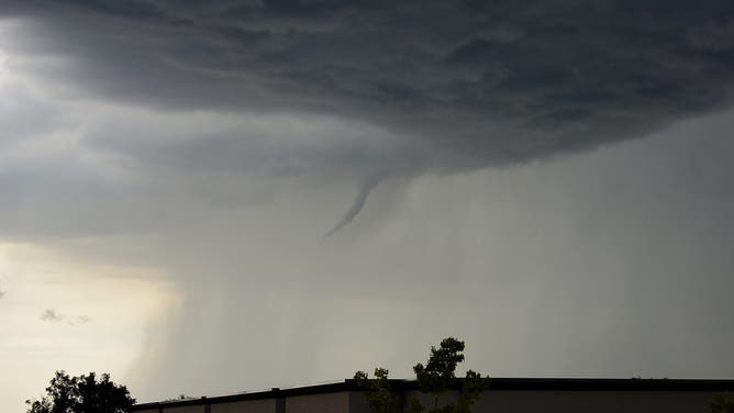 ENGLEWOOD, CO - AUGUST 11: Funnel cloud comes out of the clouds as storms brew August 11, 2015.