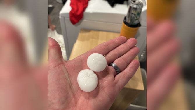 Golf ball-sized hail falls across Faribault, Minnesota Monday.