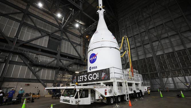 FILE: Technicians with NASA’s Exploration Ground Systems team prepare for integration to attach the agency’s Orion spacecraft on top of the SLS (Space Launch System) rocket in High Bay 3 of the Vehicle Assembly Building at NASA’s Kennedy Space Center in Florida on Friday, Oct. 17, 2025, for the agency’s Artemis II mission.