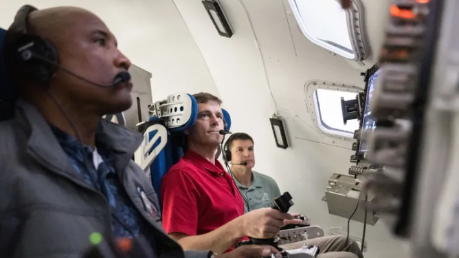 NASA astronauts Victor Glover and Reid Wiseman, and CSA (Canadian Space Agency) astronaut Jeremy Hansen train during an Artemis II simulation