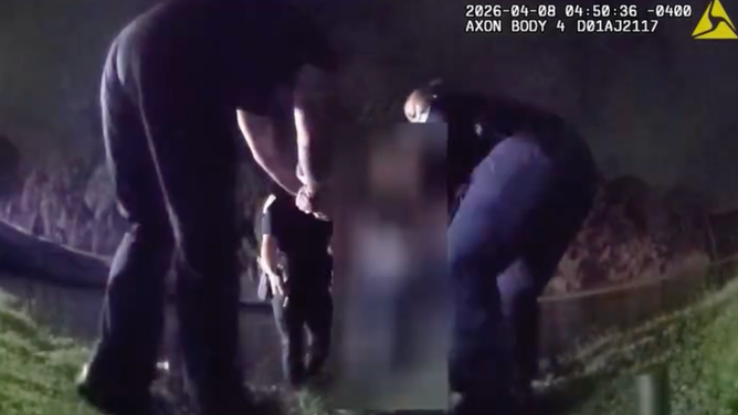 Officers carefully guide the elderly couple individually to the shore. 