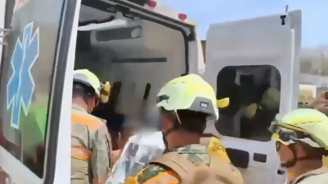 The rescuers put the miner into an ambulance after getting him out of the mine.