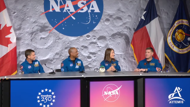 Artemis II's crew answers questions about their mission on April 16, 2026 with their ZGI mascot "Rise" at NASA's Johnson Space Center.