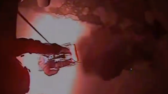 The Coast Guard pulls a person up into the helicopter.