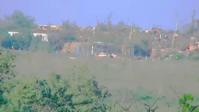 Photo shows damage to several homes and buildings in the distance in Enid, Oklahoma.