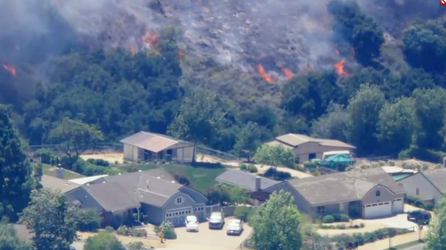 Mandatory evacuations underway as wildfire threatens several homes and structures in Southern California