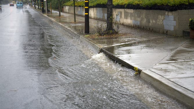 Heavy rains flow down streets into Street Gutters and Storm Drains and eventually Ballona Creek, a nine-mile waterway that drains the Los Angeles basin. Urban runoff carries an assortment of trash and debris from catch basins where a network of pipes and open channels create a pathway to the Ocean at Santa Monica Bay. Culver City, Los Angeles, California, USA. Culver City, Los Angeles, California,