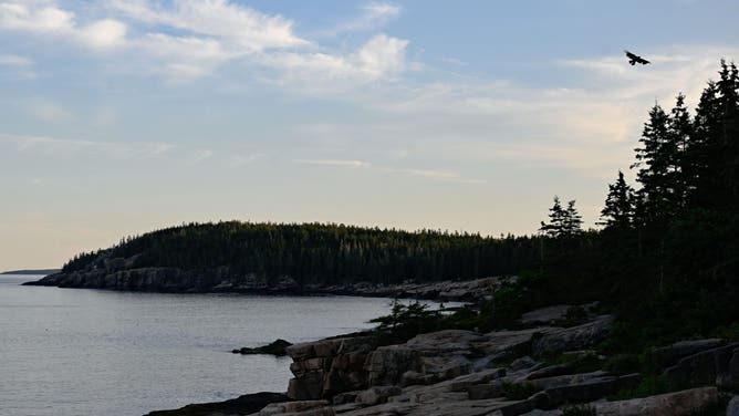Acadia, ME - August 1: The sun sets over the rocky shoreline off Park Loop Rd. in Acadia National Park on August 1, 2025. 