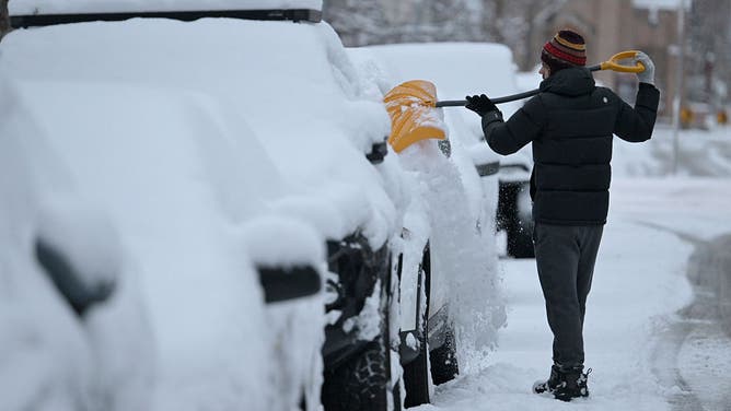 FILE - DENVER, CO - JANUARY 9 : Jono Young of Denver clears snow off his car in Denver, Colorado on Friday, January 9, 2026.