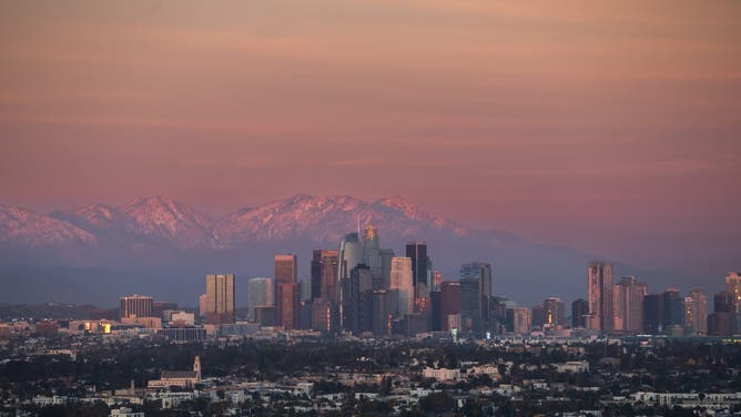 CULVER CITY, CALIFORNIA - FEBRUARY 23 : A view of the downtown Los Angeles skyline with the snow-capped San Gabriel Mountains in the background seen from the Culver City Stairs on February 23, 2026 in Culver City, California