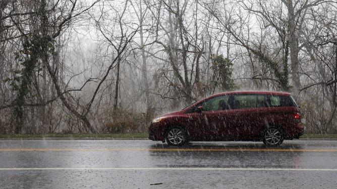 WASHINGTON, DC - MARCH 16: A car drives through heavy rain on Clara Barton Parkway on March 16, 2026 in Washington, DC. Severe storms brought high winds, thunderstorms and tornado warnings to parts of Washington, D.C. and Maryland on Monday.