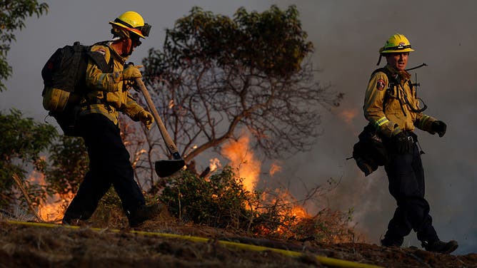 SIMI VALLEY, CALIFORNIA - MAY 18: Cal Fire firefighters battle the Sandy Fire on May 18, 2026 in Simi Valley, California.