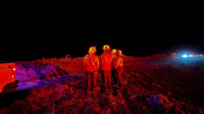 First responders wait for the remaining victims who can't swim that are stuck in a cave in California.