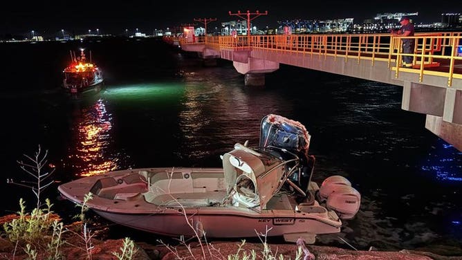 The crashed boat into the rocks outside Boston Logan International Airport on Wednesday night.