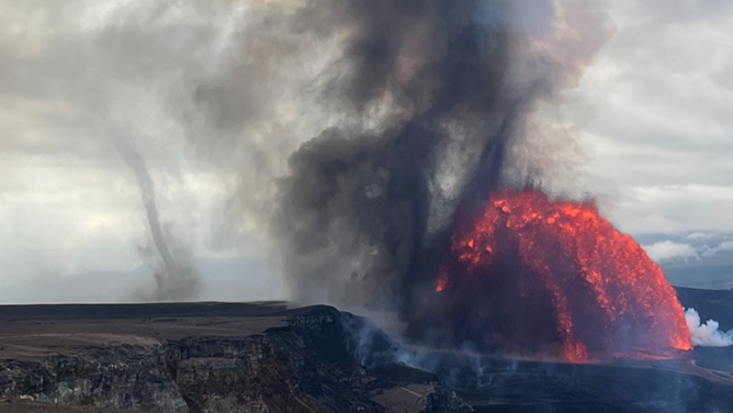 A dark gray ash- and tephra-laden puahiohio (whirlwind) downwind (to the left) of the Episode 38 lava fountains on 6 December 2025. kilauea-tephra-devil A dark gray ash- and tephra-laden puahiohio (whirlwind) downwind (to the left) of the Episode 38 lava fountains on 6 December 2025.