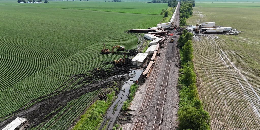 Drone video captures double-stack train cars toppled over after destructive winds tore through Illinois