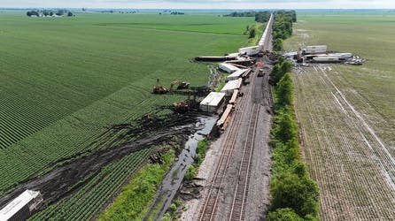 Drone video captures double-stack train cars toppled over after destructive winds tore through Illinois