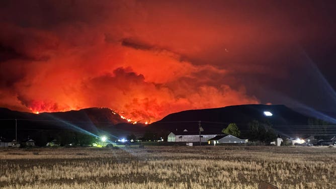 The Cottonwood Fire glows orange in the distance in Fishlake National Forest.