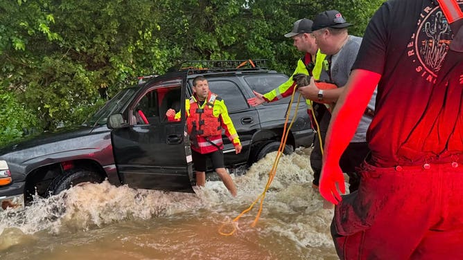 Firefighters work on multiple water rescues in Columbus, Kansas Monday.