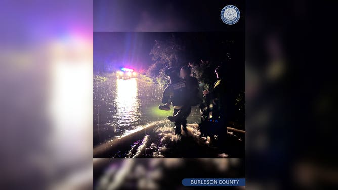 First responders rescue five people from vehicles that had been swept off roadway.