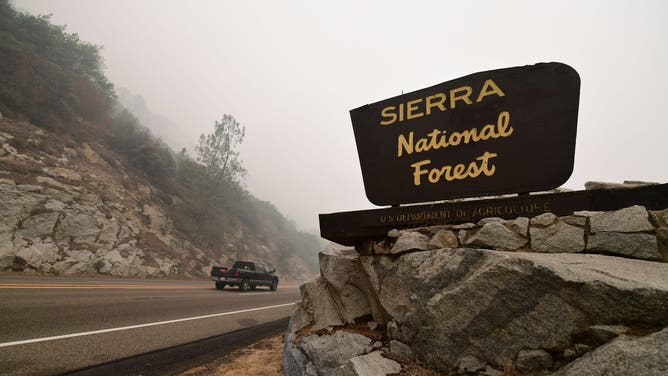 A vehicle enters the Sierra National Forest northeast of Fresno in the foothills of the Sierra Nevada mountains under a smoke-filled sky during the Creek fire in Auberry, Fresno County on September 11, 2020. - More than 20,000 firefighters from across the United States on Friday battled sprawling deadly wildfires up and down the West Coast -- a wave of infernos that have forced more than half a million people to flee their homes.