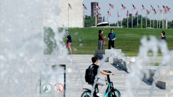 WASHINGTON, DC - AUGUST 28: Visitors walk around the fountain of the World War II Memorial on August 28, 2024 in Washington, DC. 