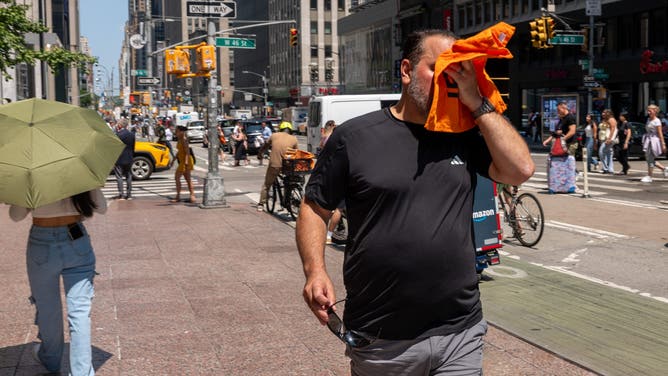 NEW YORK, NEW YORK - JULY 29: People try to stay cool on the sweltering streets of Manhattan as the region experiences another heatwave on July 29, 2025 in New York City. Temperatures are expected to reach into the high 90s with a heat index well above 100 degrees.