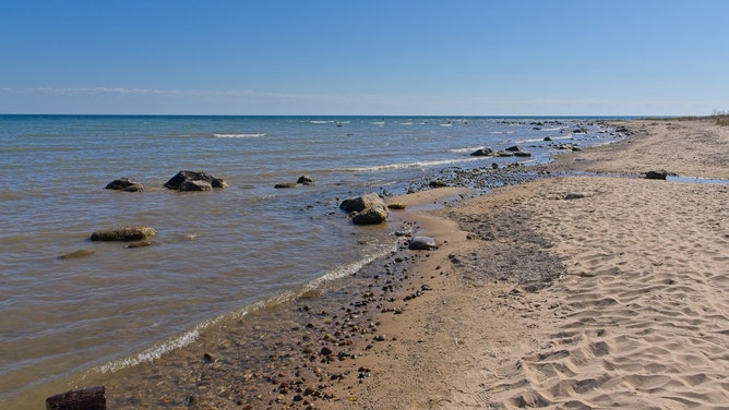 Sandy beach along the lake Huron coast of northeast Michigan, near Alcona and the Sturgeon Point lighthouse.