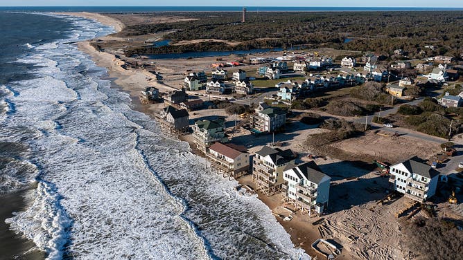 BUXTON, NC - MARCH 19 : An aerial view of the recently moved house (bottom right) and a few other houses that are slated to be moved back from the approaching ocean March 19, 2026 in Buxton NC. 