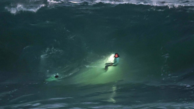 Laguna Beach, CA - June 9, 2026: Laguna Beach lifeguards search the beach below the Montage Resort where a girl was swept off the rocks by big waves on Tuesday in Laguna Beach, CA on June 9, 2026.