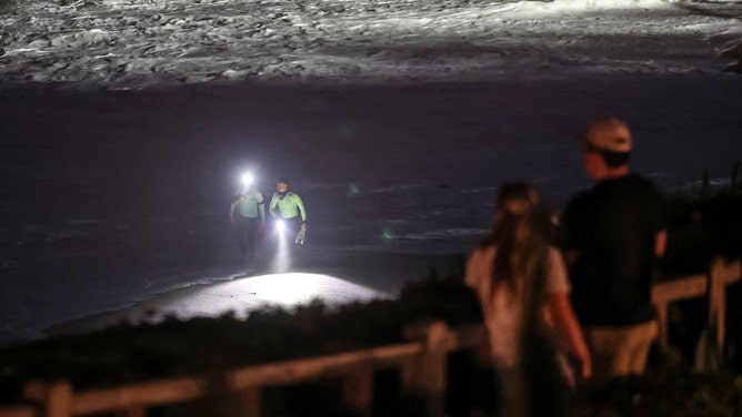 Laguna Beach, CA - June 9, 2026: Laguna Beach lifeguards search the beach below the Montage Resort where a girl was swept off the rocks by big waves on Tuesday in Laguna Beach, CA on June 9, 2026.
