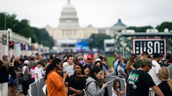 WASHINGTON, DC - JUNE 28: Visitors stand in line to ride the 110-foot "Freedom 250" ferris wheel on the fourth day of the "Great American State Fair" on the National Mall on June 28, 2026 in Washington, DC. 