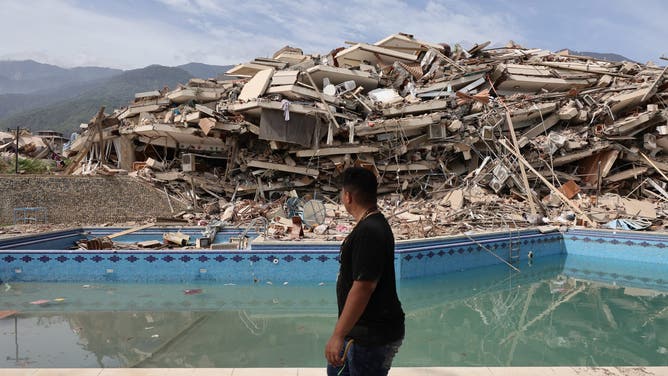 LA GUAIRA, VENEZUELA - JUNE 25: A person walks amid debris of demolished buildings as rescue efforts continue after a magnitude 7.2 earthquake struck Venezuela and other regions in the Caribbean on June 25, 2026 in La Guaira, Venezuela.