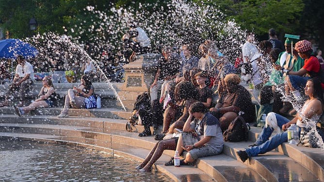 NEW YORK, UNITED STATES - JUNE 29: People spend time at Washington Square Park during hot weather in New York City, United States, on June 29, 2026.