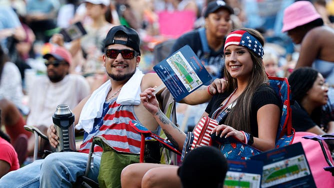 GAINESVILLE, TEXAS - JUNE 29: Blake McCoy of Gainesville, Texas and his fiancee Stephany Robles sit together during Klyde Warren Park's Independence Day Celebration, Saturday, June 29, 2024, in Dallas. 