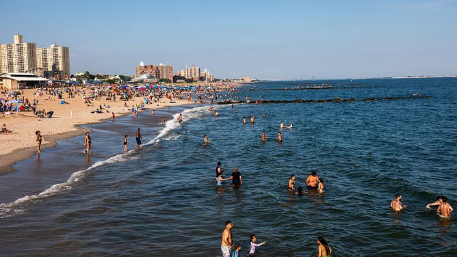 NEW YORK CITY - JUNE 29: People cool off at Coney Island beach on June 29, 2026 in the Brooklyn borough of New York City. 