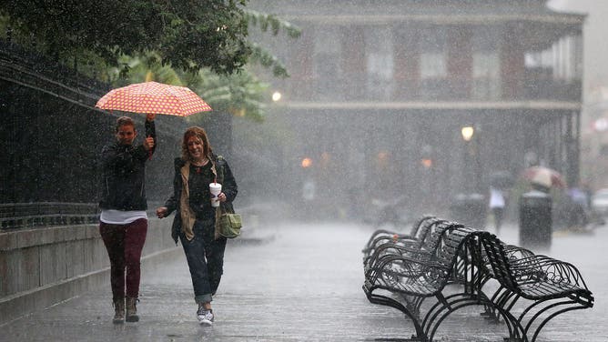 NEW ORLEANS, LA - OCTOBER 07: Tourists run to avoid the rain as strong winds and heavy rain from Hurricane Nate begin to come ashore on October 7, 2017 in New Orleans, Louisiana. Nate is expected to make landfall as a category 2 hurricane near Biloxi, Mississippi later this evening.