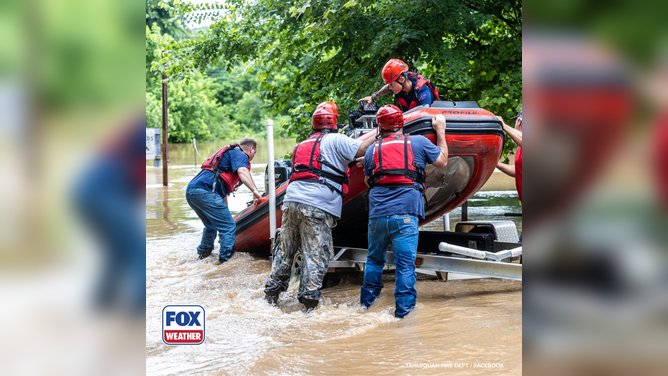 First responders utilize a rescue boat to safely extract campers.