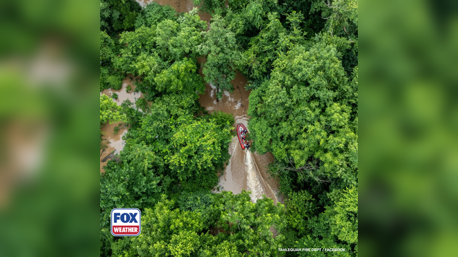 First responders navigate a rescue boat to locate stranded campers.