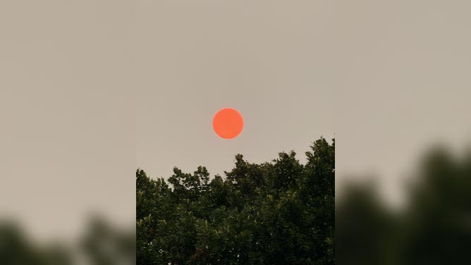 Bright orange sun in Massachusetts surrounded by a smoky sky Tuesday night