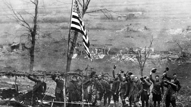 Gun from Battery D, 105th Field Artillery, showing American flag, hoisted after last shot was fired when the armistice took effect, Etraye, France, U.S. Army Signal Corps, November 11, 1918.
