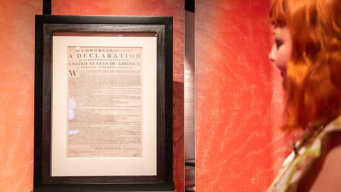 A member of staff views the United States of America Declaration of Independence, printed by John Dunlap in Philadelphia on the night of 4 July, 1776, at a photocall ahead of the exhibition: Revolution 250: America's Independence Story 1763-1783 at The National Archives in Kew, west London on June 22, 2026.