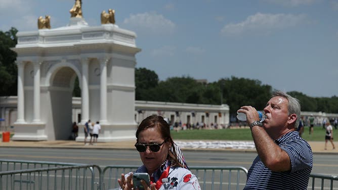 WASHINGTON, DC - JULY 02: A man drinks from water bottle during the Great American State Fair on the National Mall on July 2, 2026 in Washington, DC.