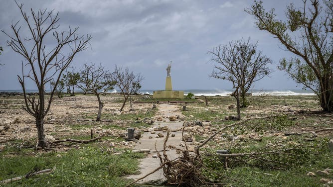 TOPSHOT - A general view shows debris washed ashore by high waves at a park in the aftermath of Super Typhoon Bavi in Guam on July 7, 2026.