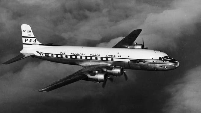 Pan American World Airways Super-6 plane the Clipper Priscilla Alden (registration number N6520C) flies over the Atlantic Ocean during one of its earliest runs between hemispheres, 1952.