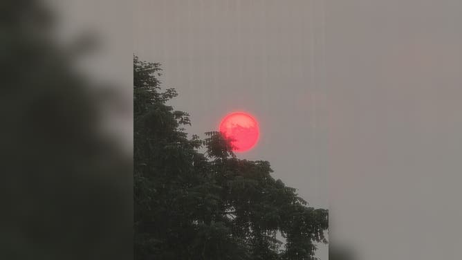 A smoky orange sun in Malone, NY, on Tuesday night