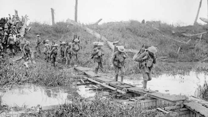 A wire carrying party cross a bridge during the battle of Pilckem Ridge, July 31, 1917.