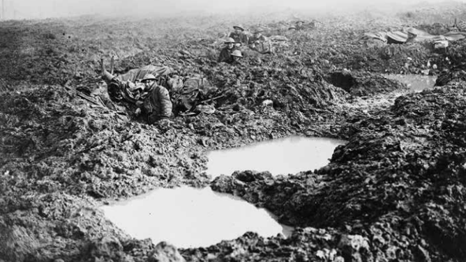 Soldiers set up around rain filled holes caused by artillery shells.